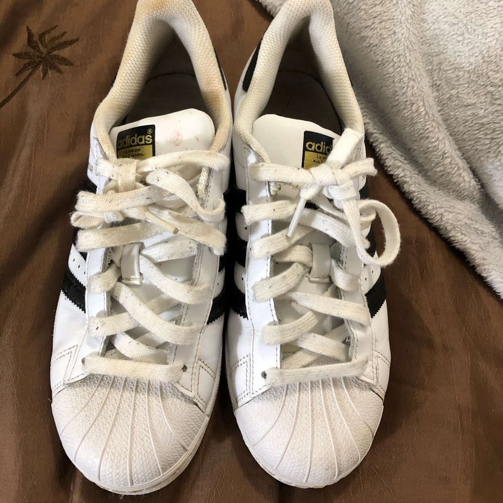 A pair of gently worn black and white Adidas